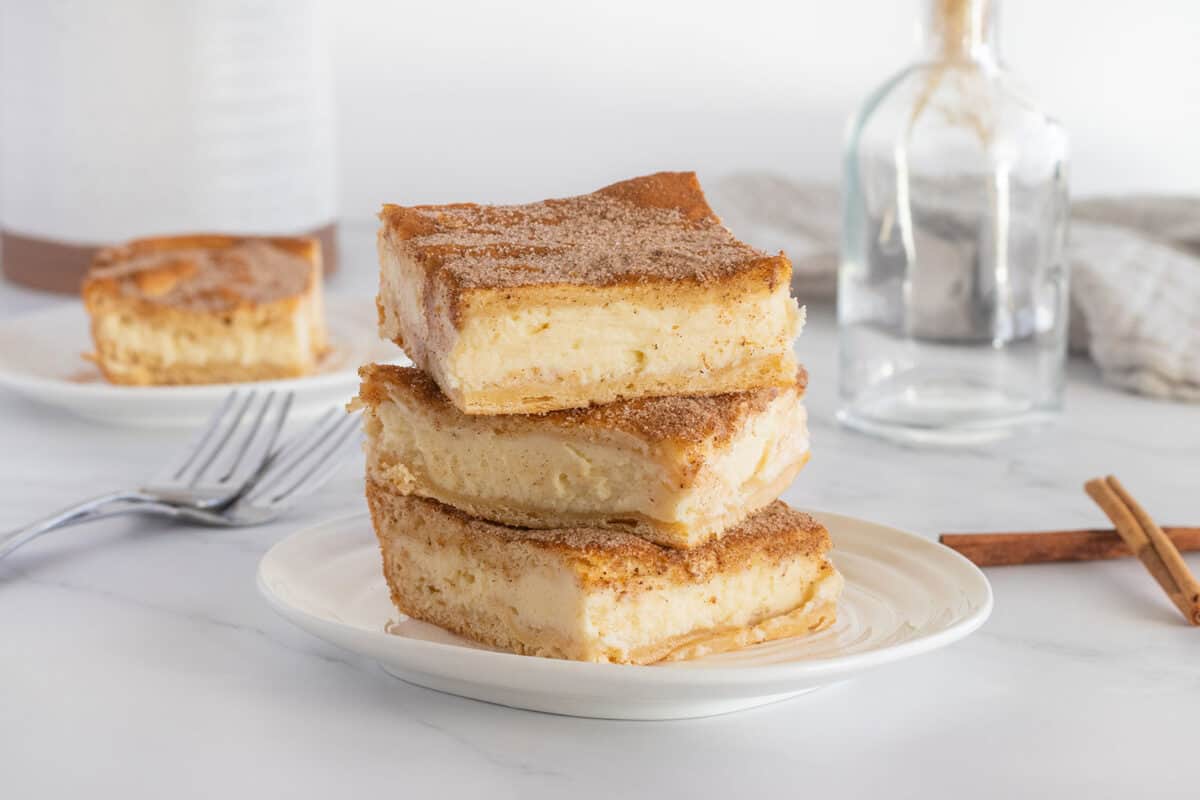 churro cheesecake bars in a stack