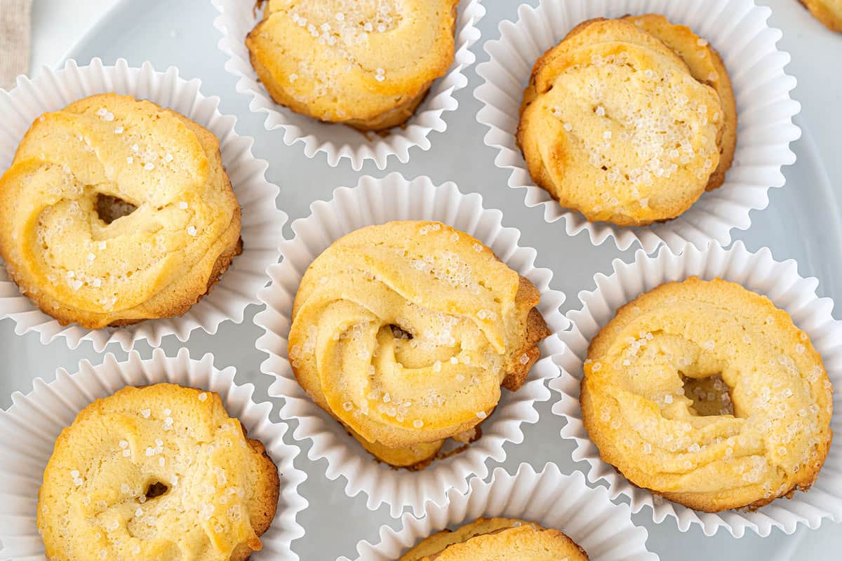 Golden Danish butter cookies arranged in a tin.