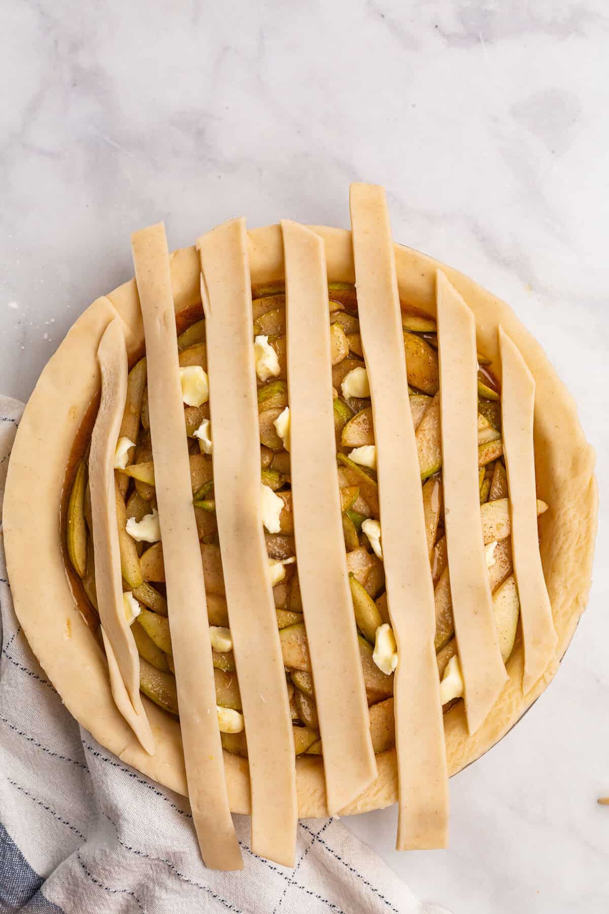 half done lattice crust on a pear pie