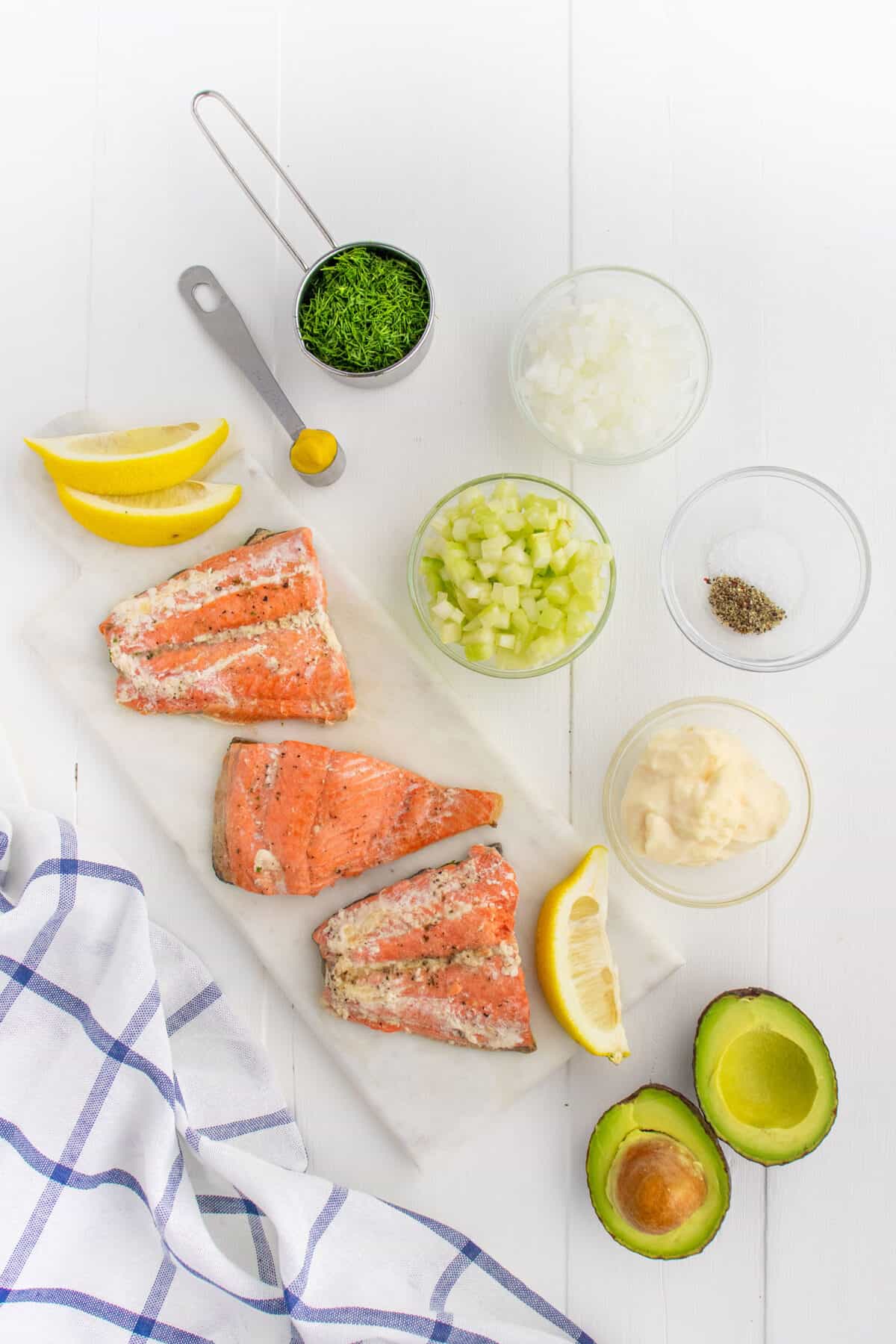 ingredients for salmon salad sandwich on a white board
