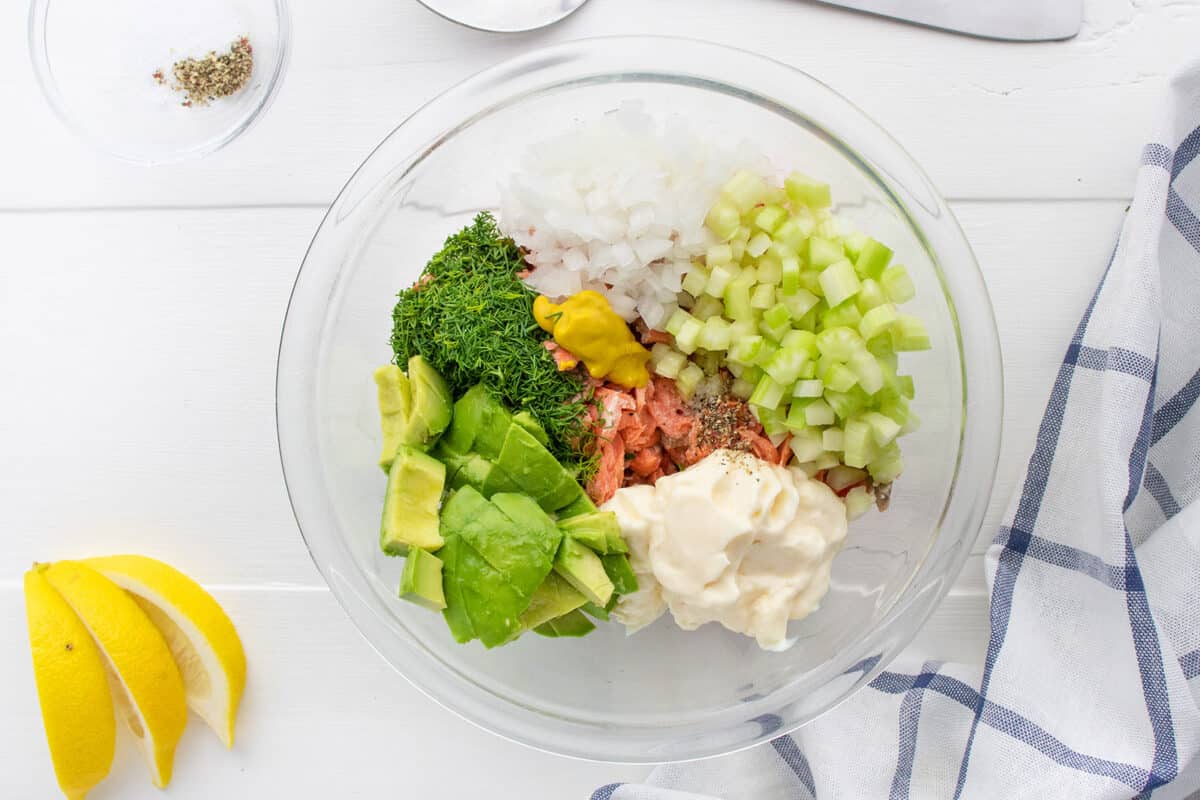 mixing salmon salad in a bowl