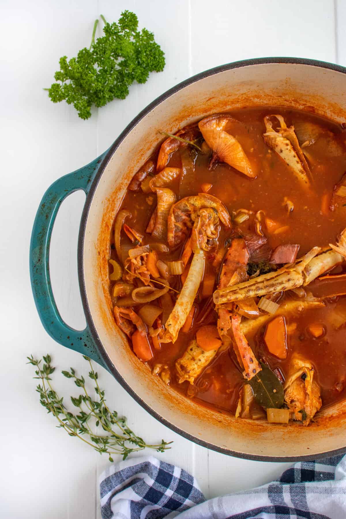seafood stock with crab leg shells and shrimp shells in a Dutch oven