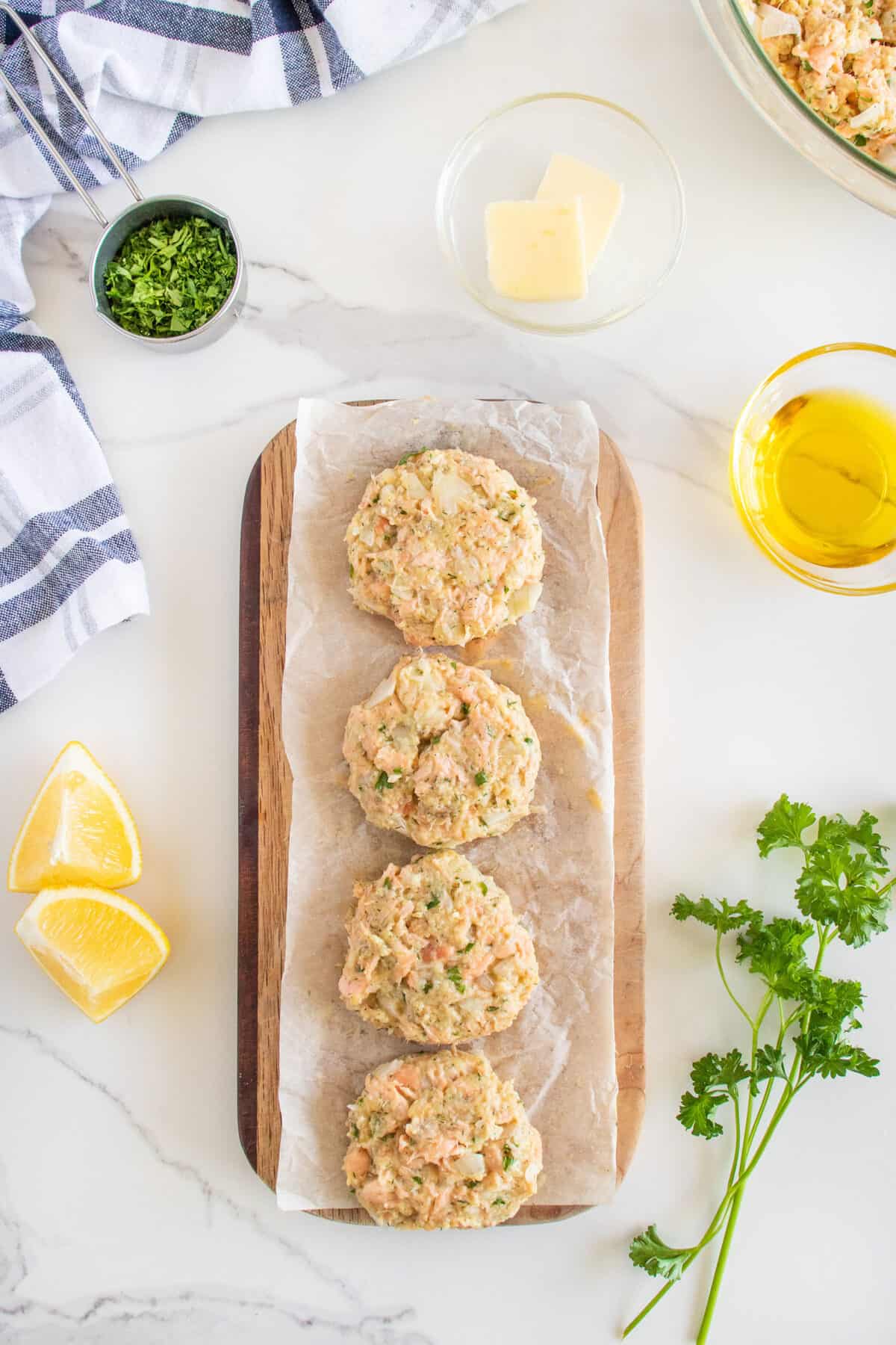 raw salmon patties on a board