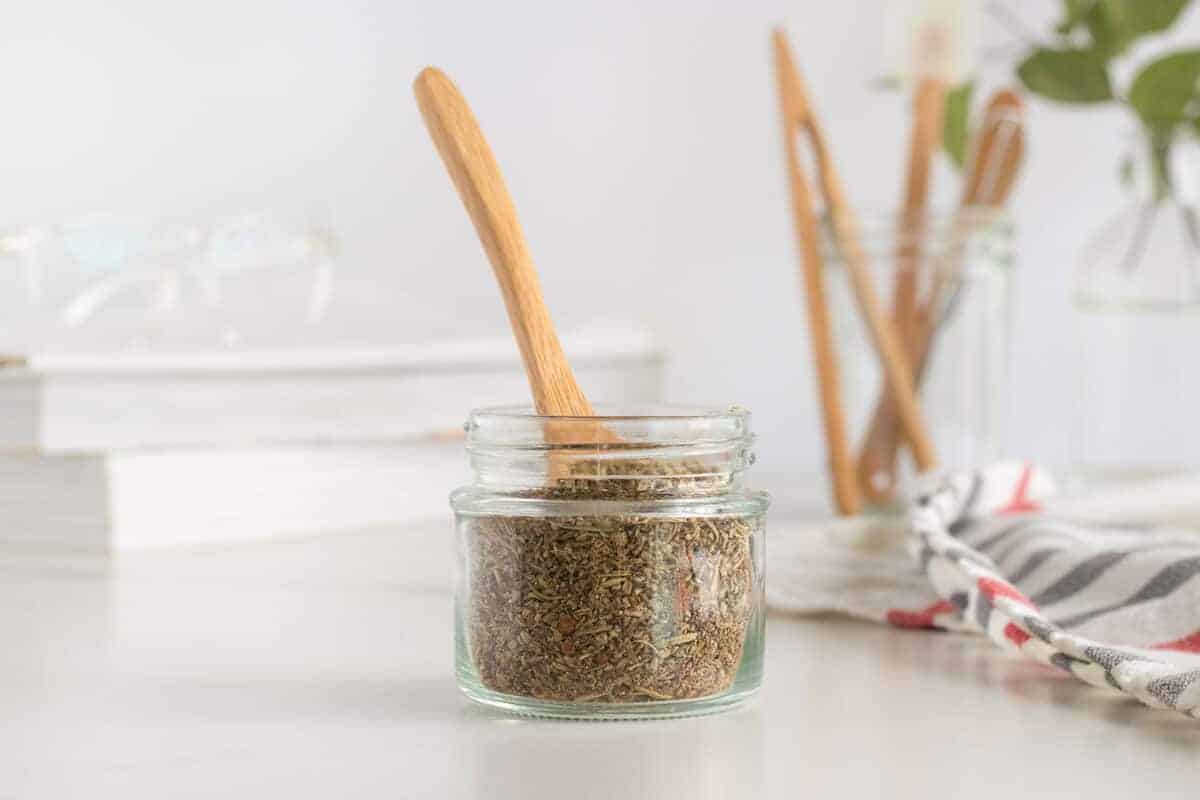 jar of poultry seasoning with a wooden spoon in it 
