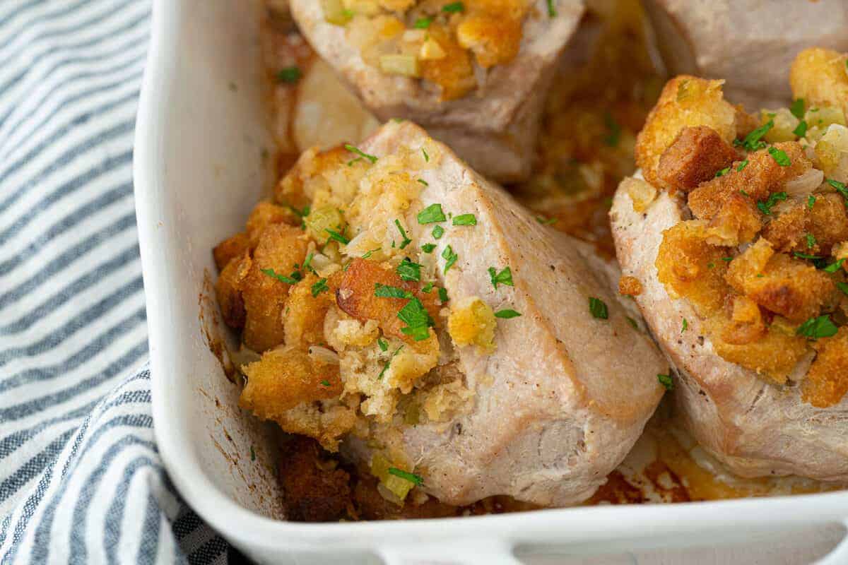 stuffed pork chops in a white baking pan