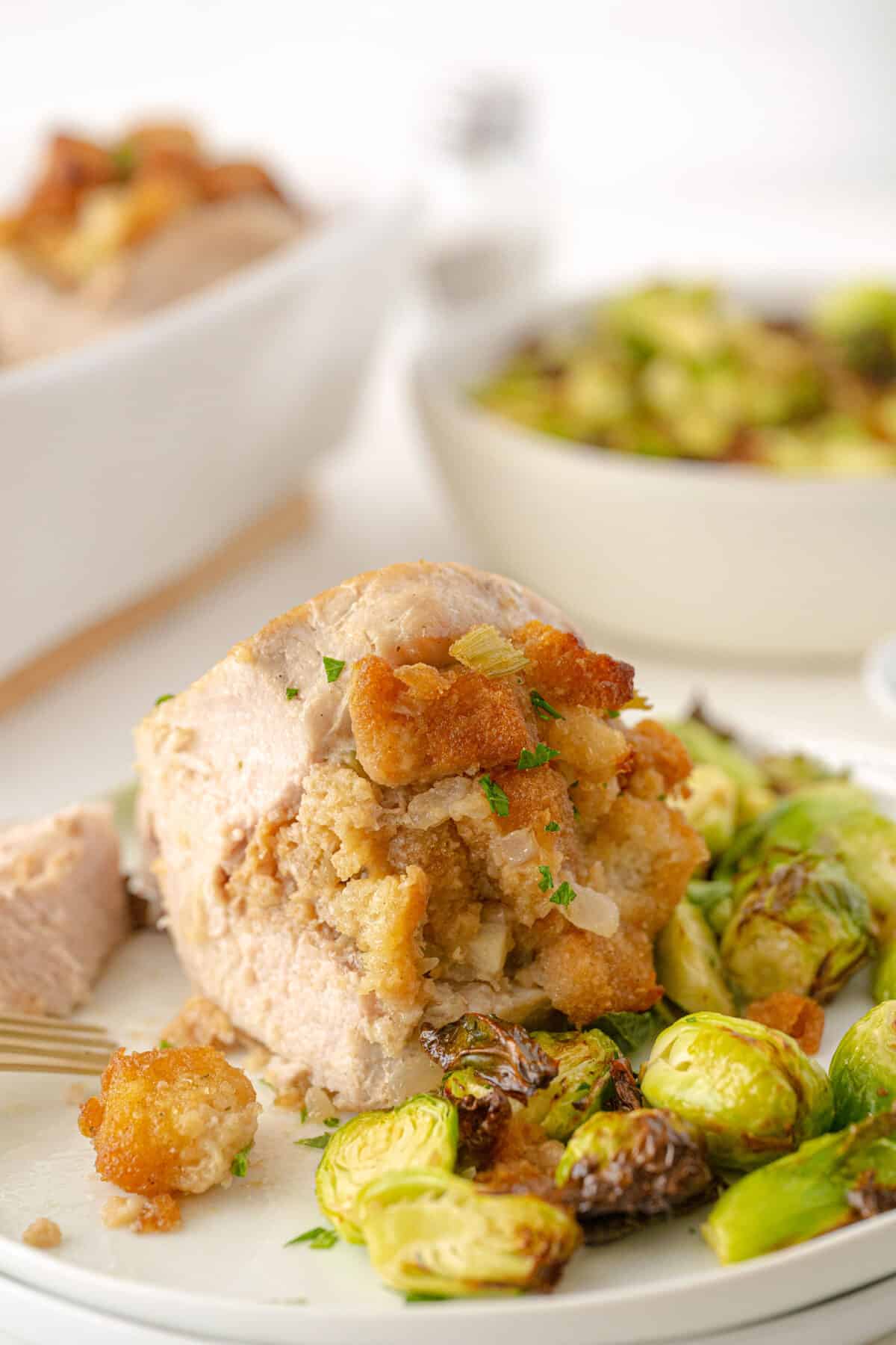 stuffed pork chops on a plate with Brussels sprouts 