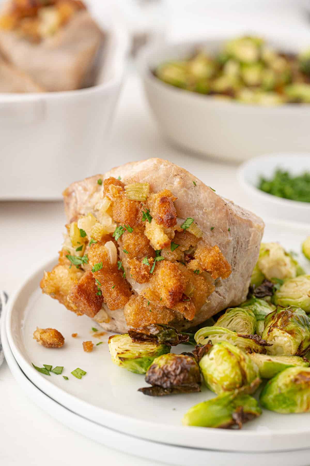 stuffed pork chops on a plate with Brussels sprouts 