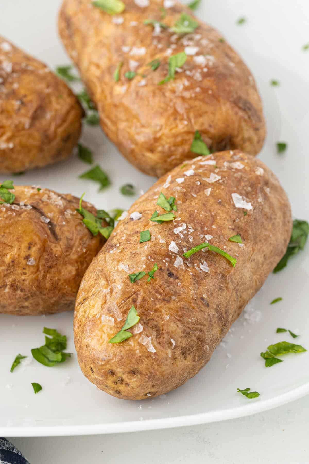 air fryer baked potato on a white plate 