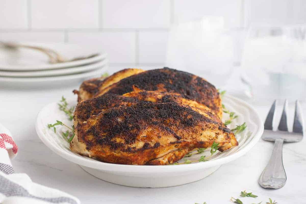 Spicy blackened chicken breasts served hot.