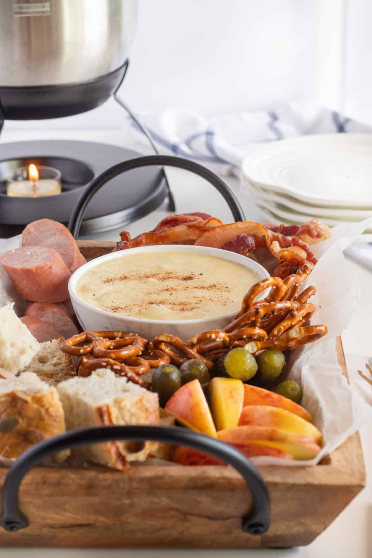 cheese fondue on a wooden board with food