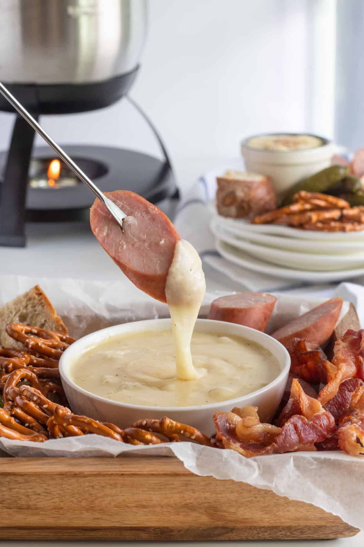 dipping sausage into cheese fondue