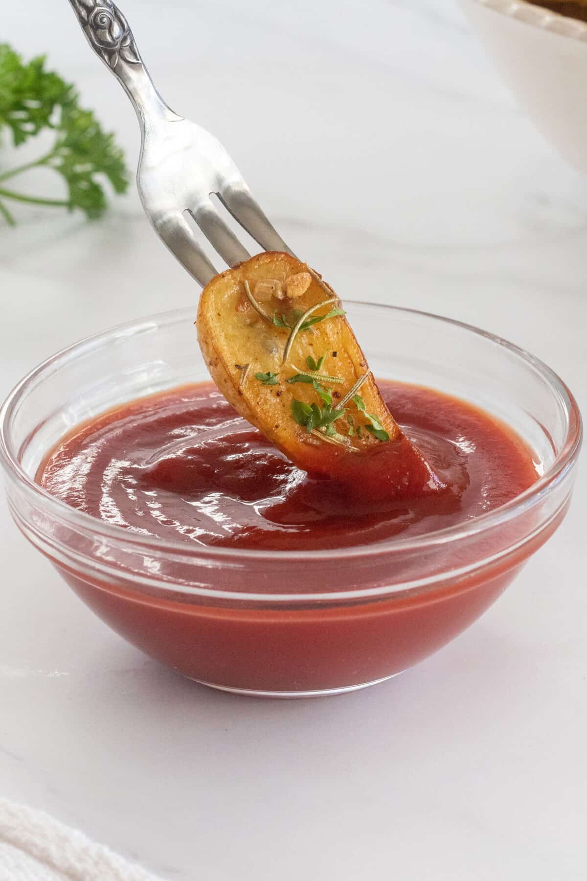 dipping roasted fingerling potatoes in ketchup