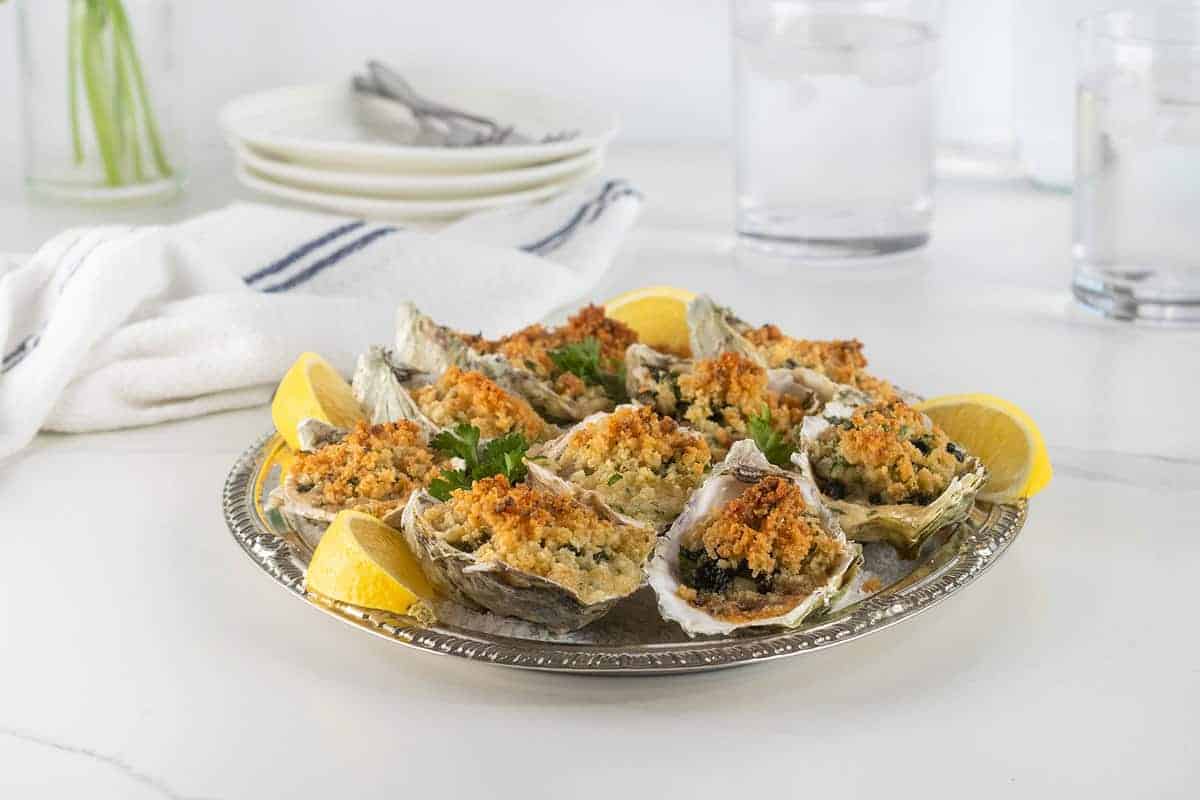 Baked oysters topped with herbs, breadcrumbs, and butter.