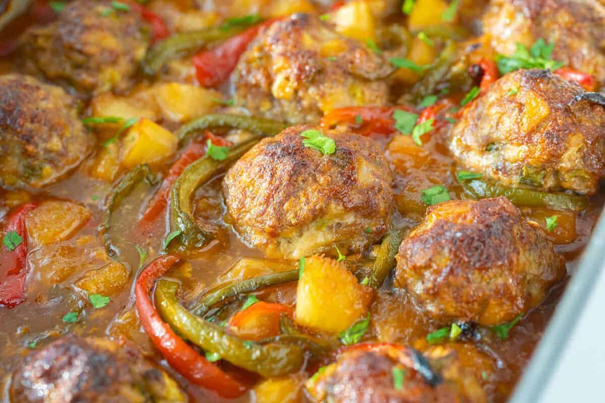 sweet and sour pork meatballs in a skillet 