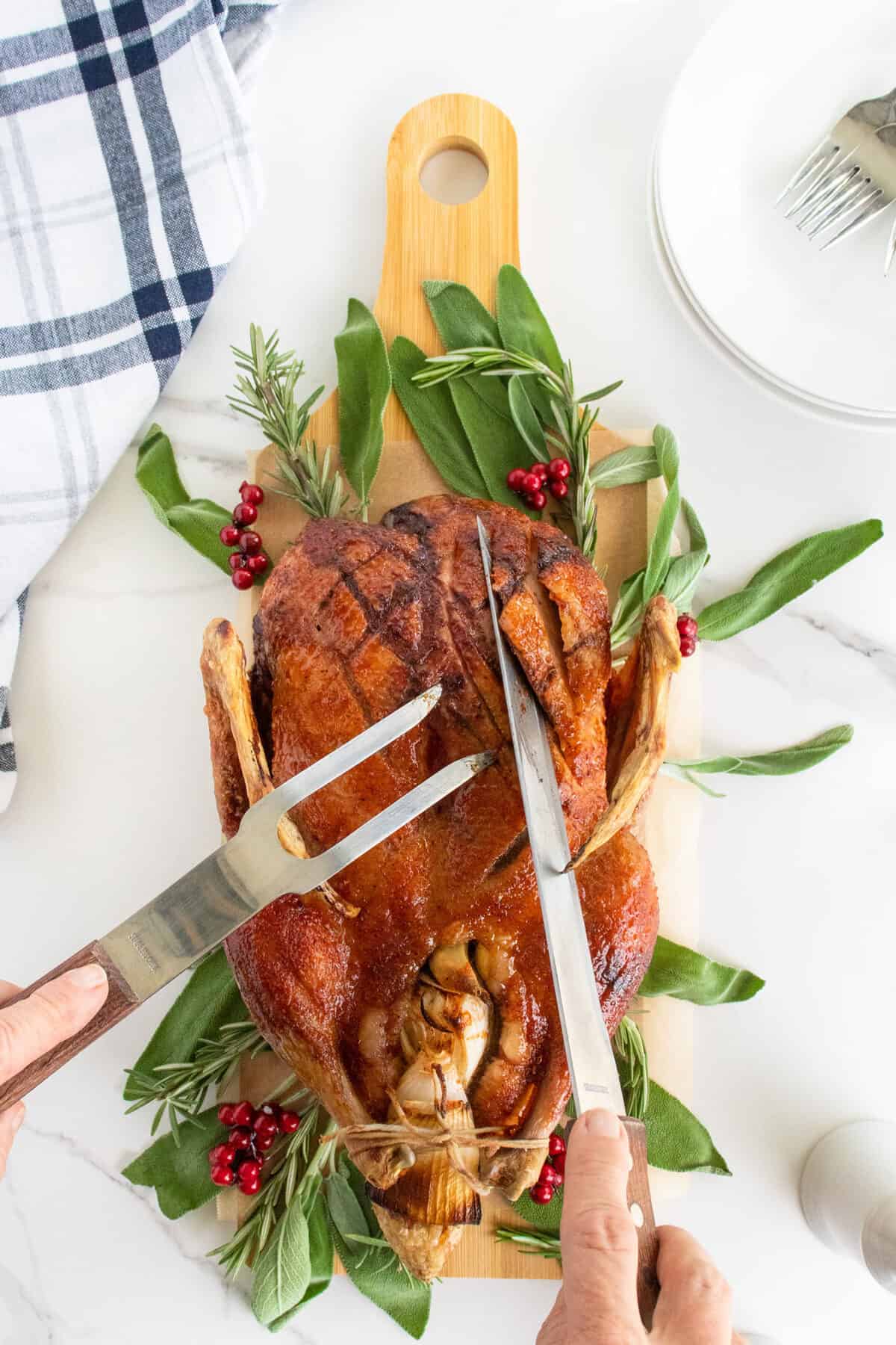 cutting a roast duck with knife and fork 