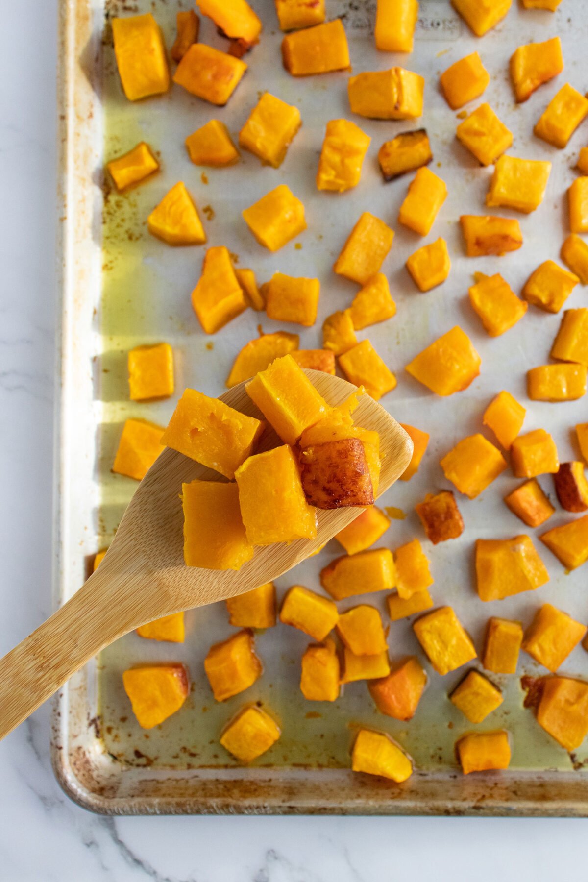 roasted butternut squash on a wooden spoon