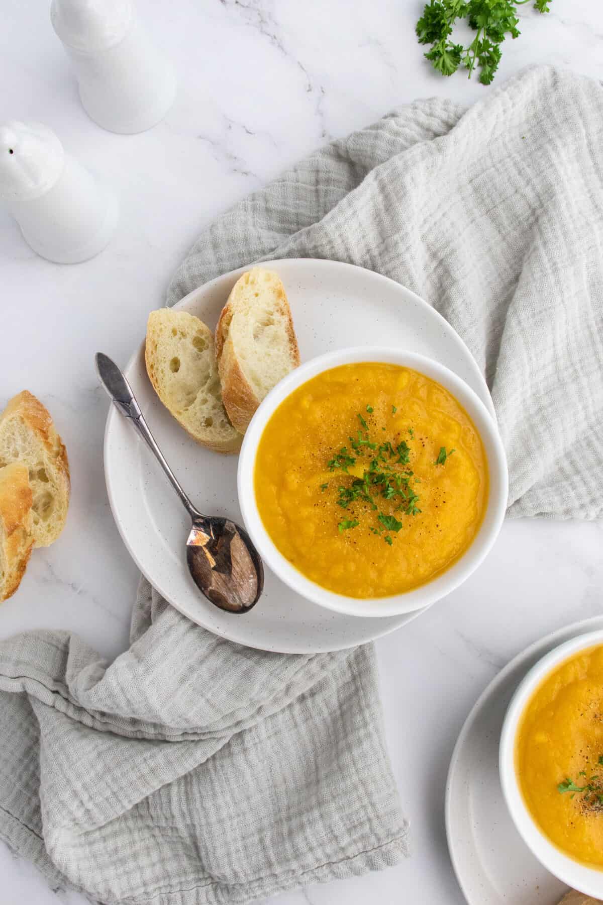 roasted butternut squash soup in a white bowl on a plate