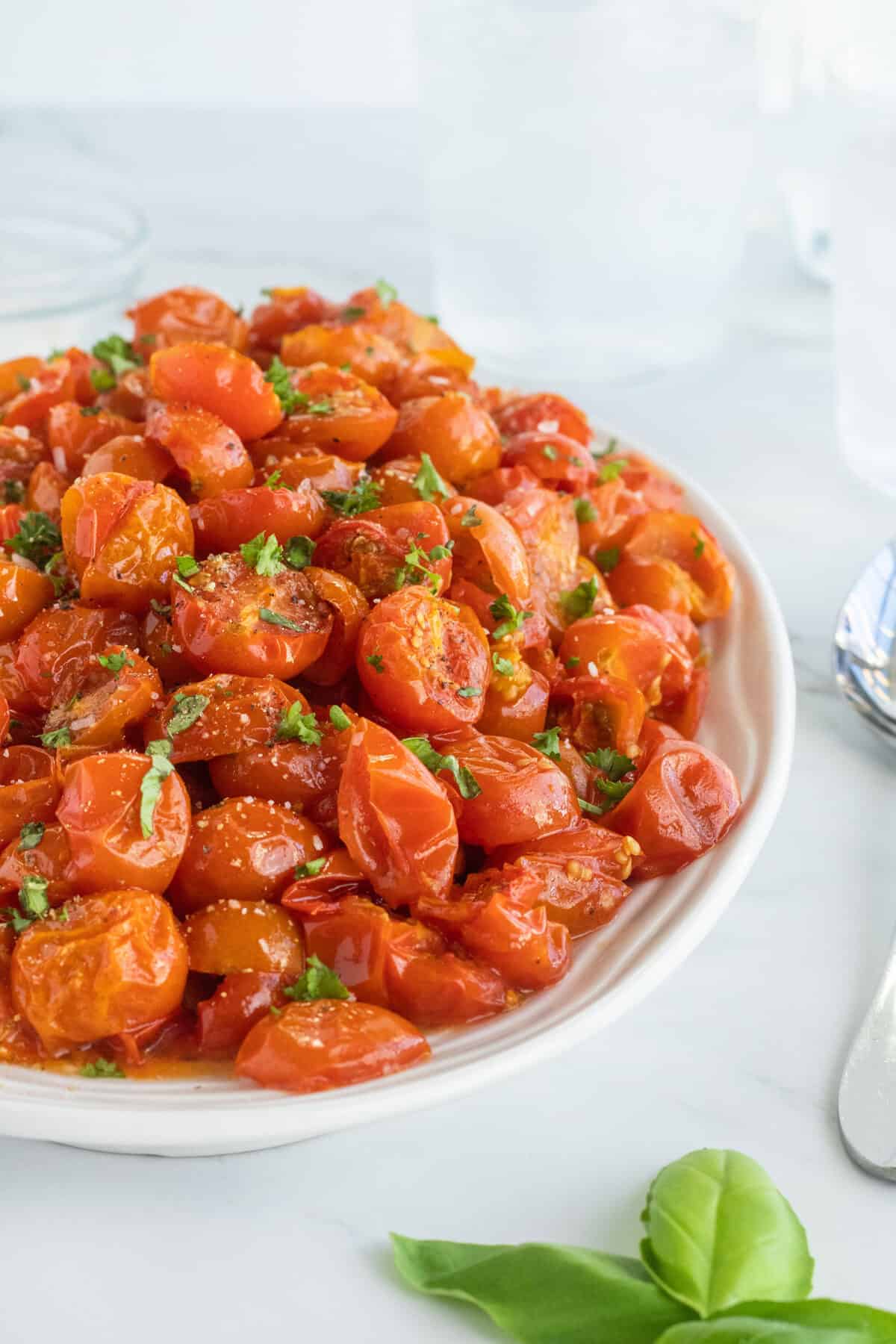 roasted cherry tomatoes in a white bowl