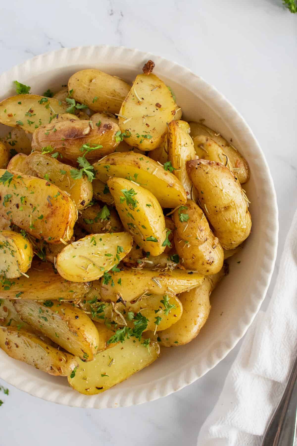 roasted fingerling potatoes in a white bowl