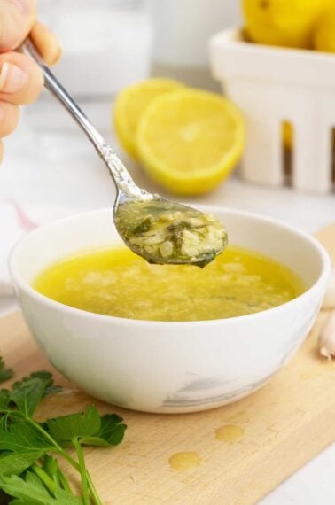 Garlic butter sauce in spoon