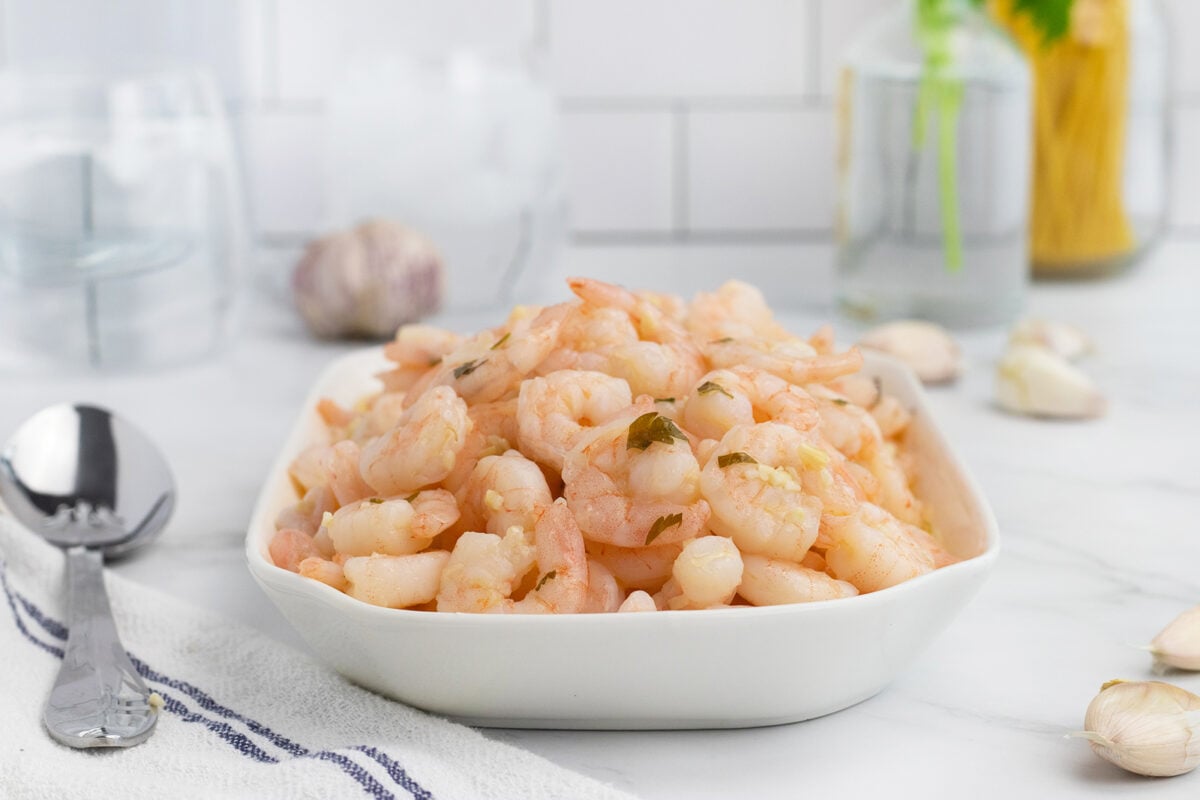 Garlic butter shrimp on platter with spoon