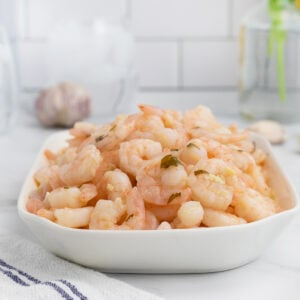 Garlic butter shrimp on platter with spoon