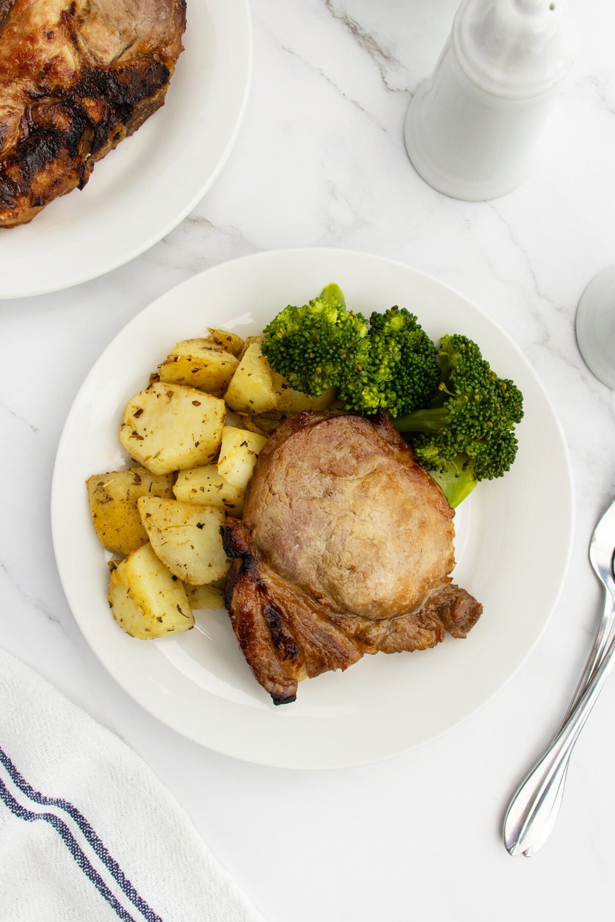 Pork chop on plate with vegetables