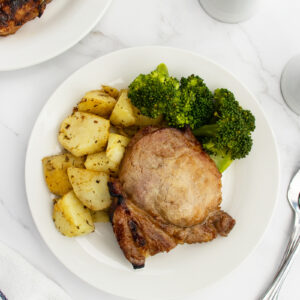 Pork chop on plate with vegetables