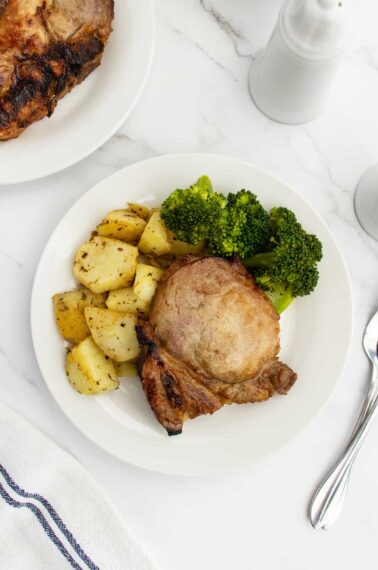 Pork chop on plate with vegetables