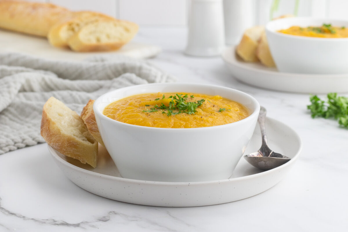 roasted butternut squash soup in a white bowl