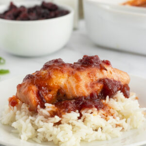 Cranberry chicken on rice and plate