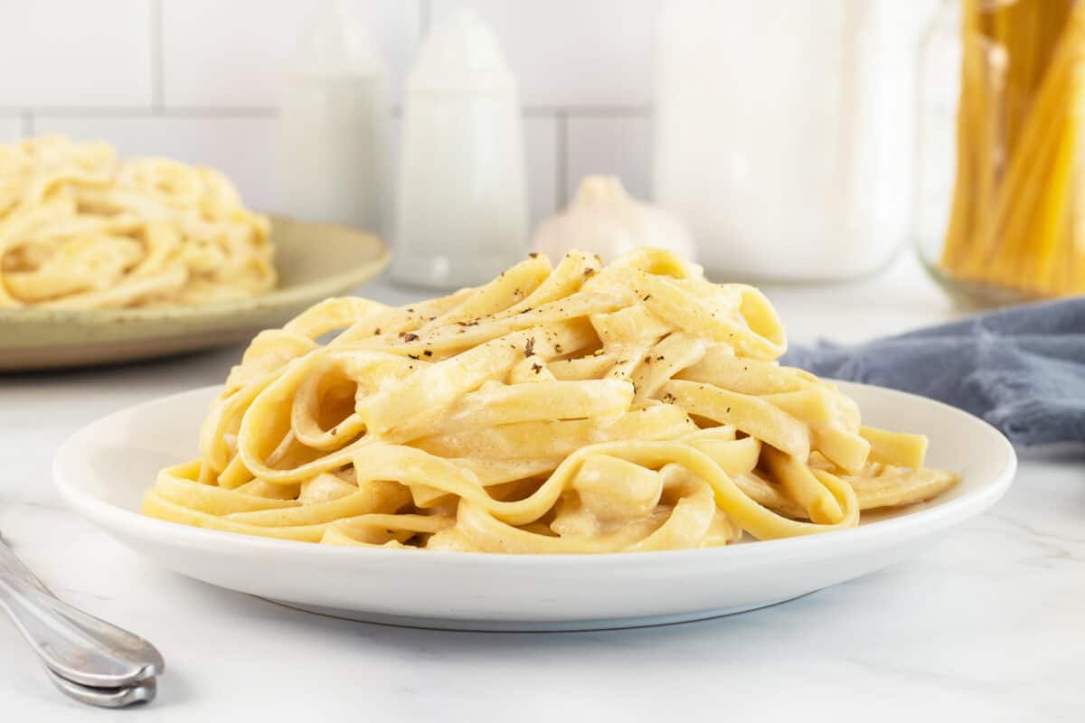 Linguine alfredo on white plate