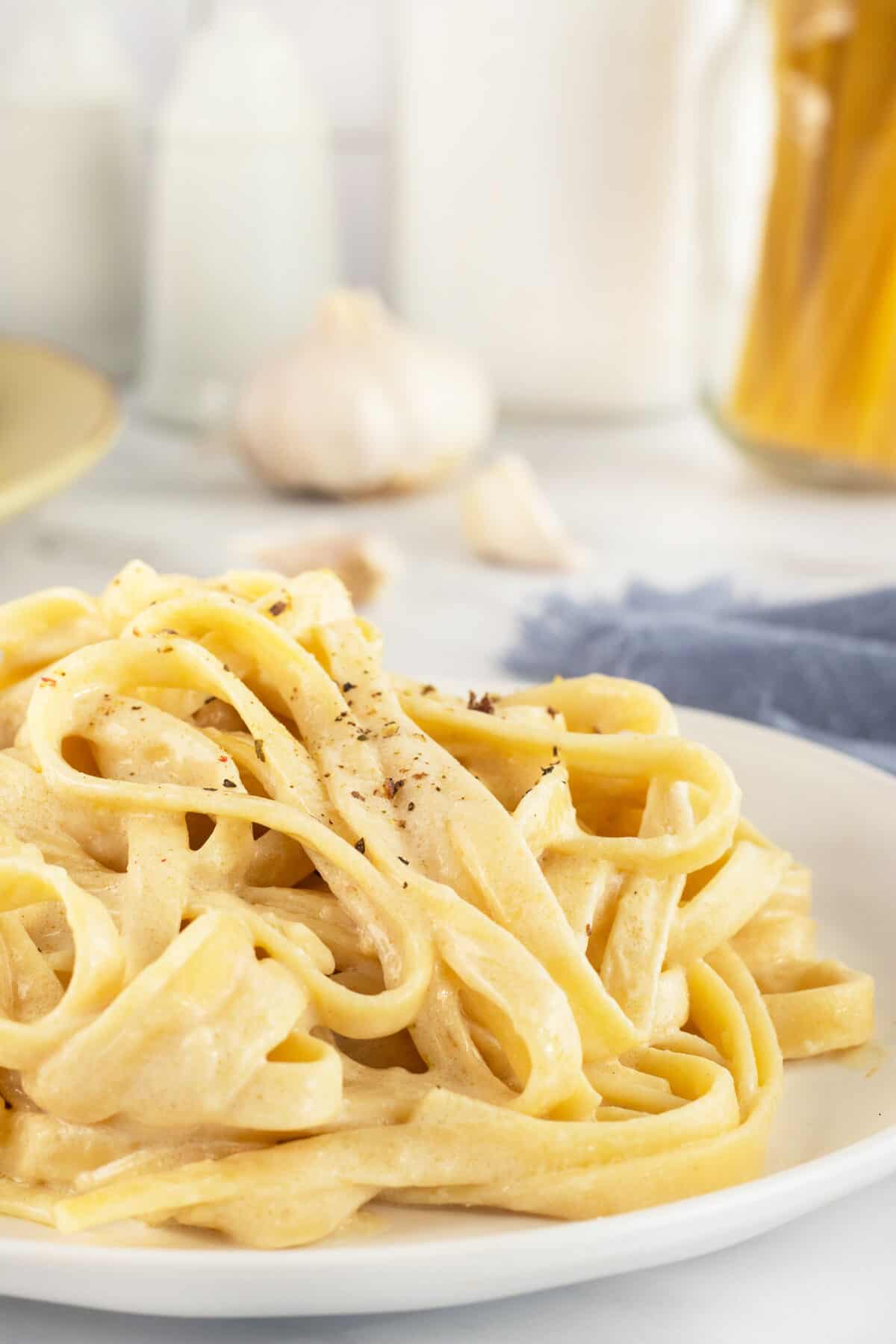 Linguine alfredo piled on white plate