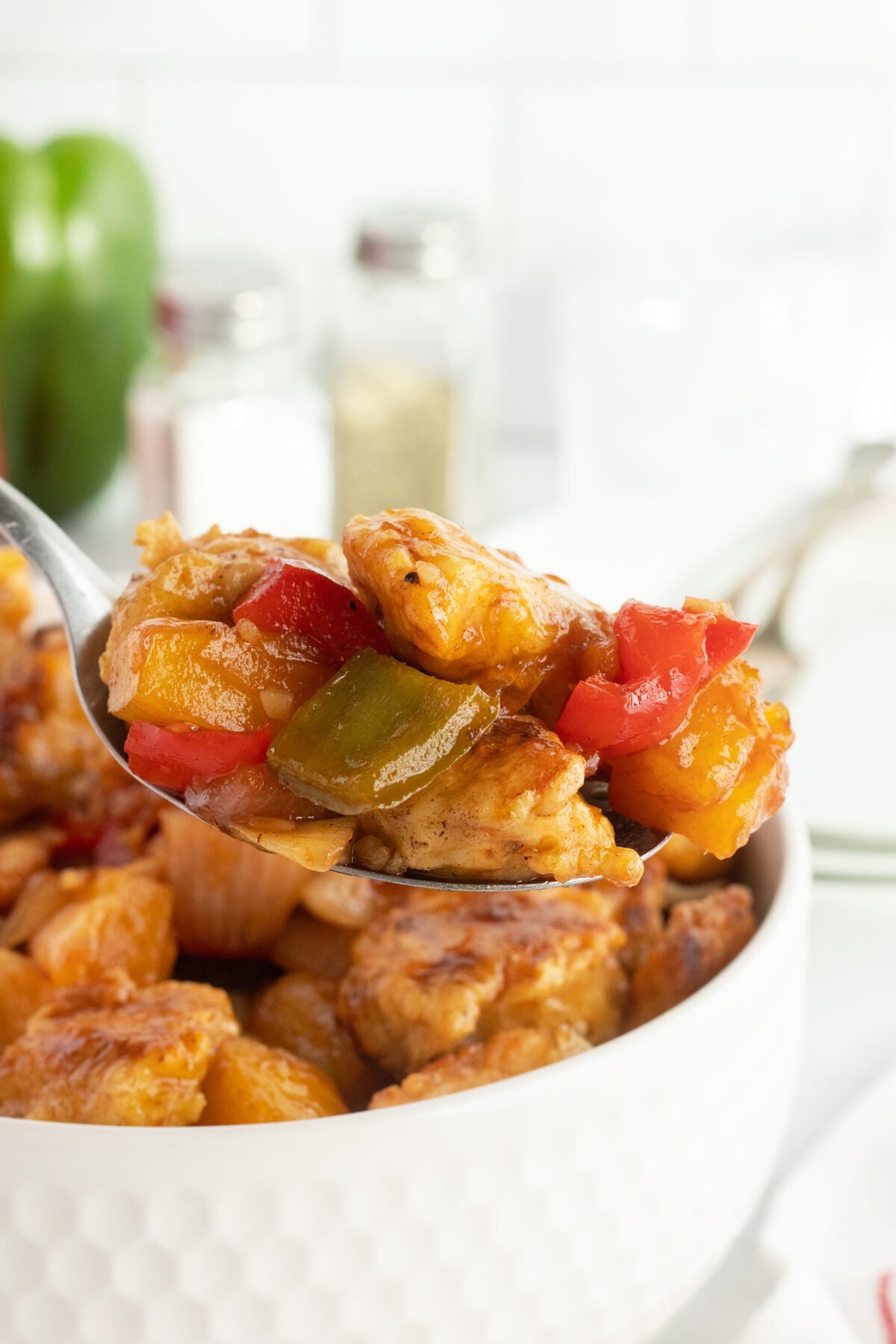 Sweet and sour chicken on spoon