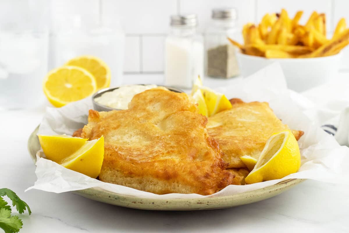 beer battered fish on a white plate