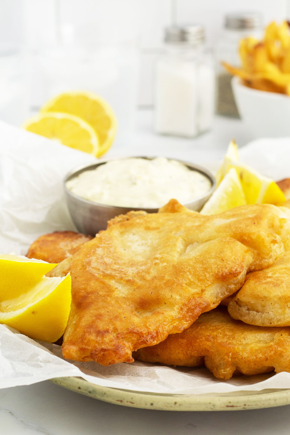 beer battered fish on a white plate