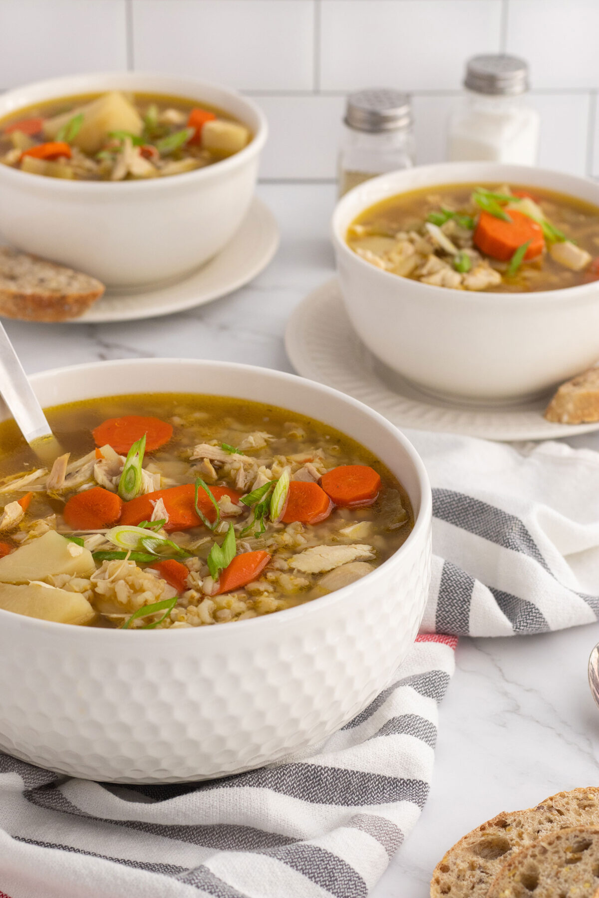 close up of a bowl of chicken barley soup