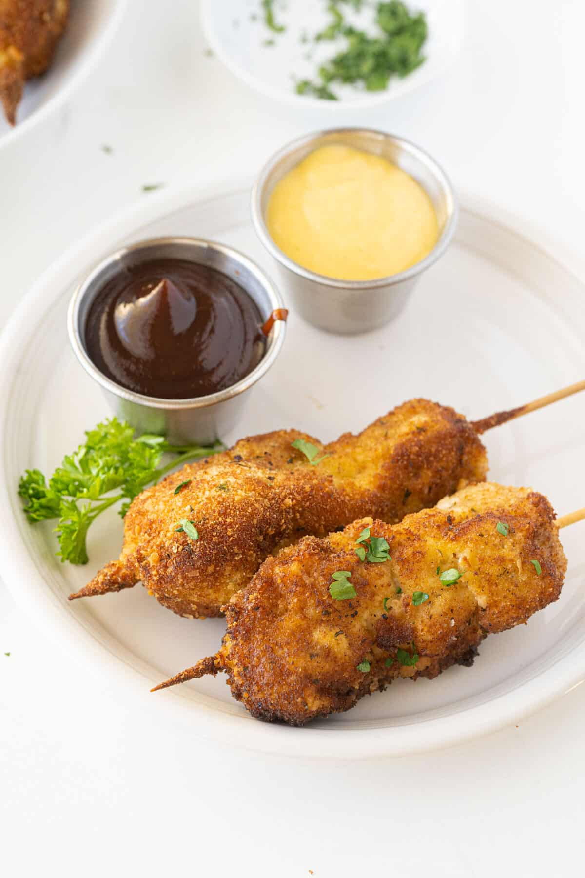 two city chicken skewers on a plate