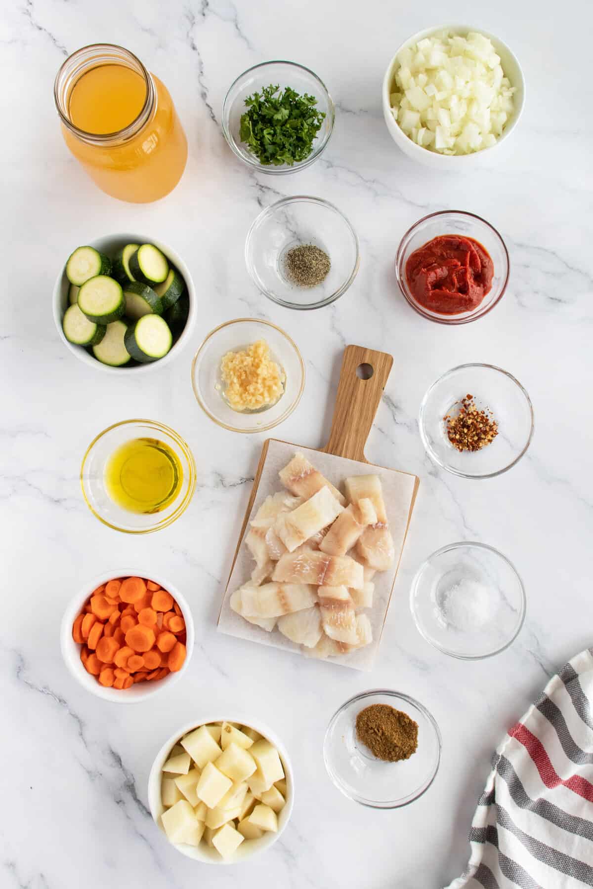 Fish stew ingredients on cutting board