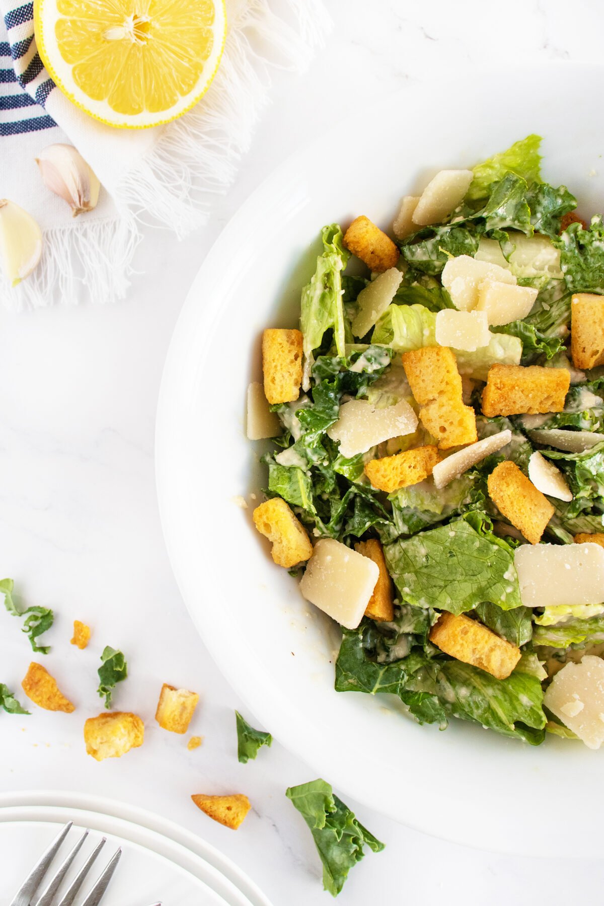 Kale caesar salad close up on white plate