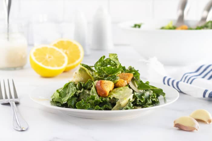 kale caesar salad on a white plate