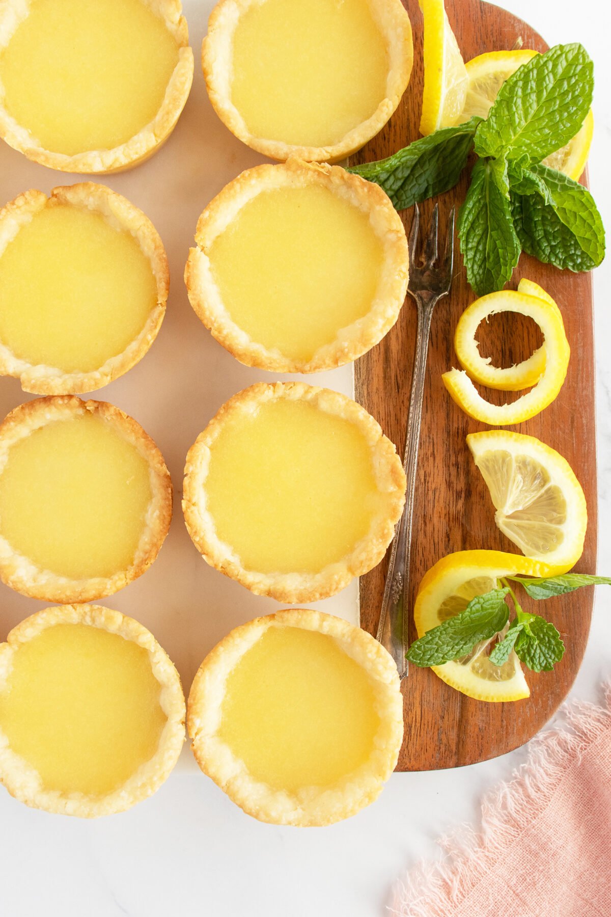 Lemon Tarts on a brown cutting board