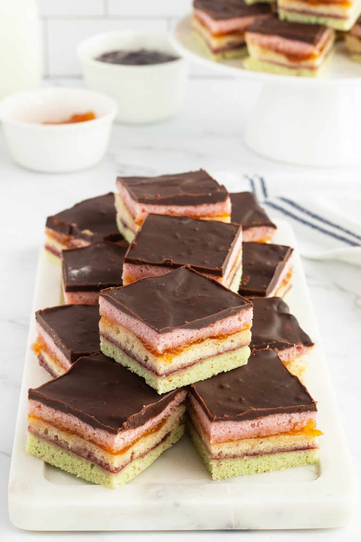 Rainbow Cookies piled on square plate