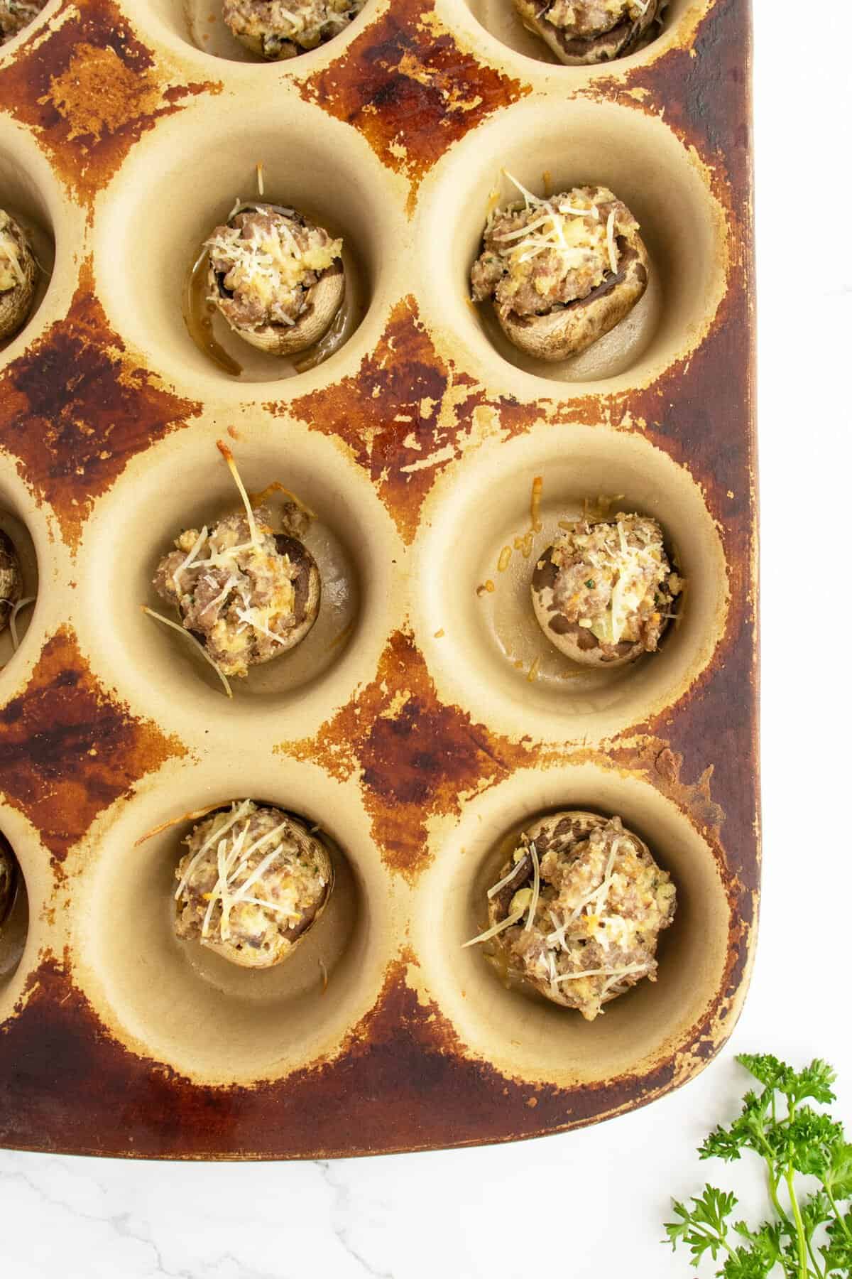 Sausage stuffed mushrooms  in a muffin tin
