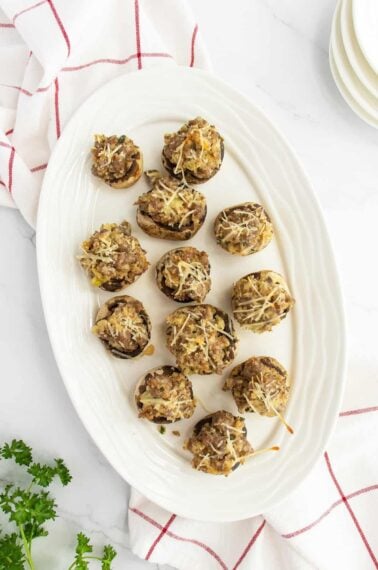 Sausage stuffed mushrooms on a white plate