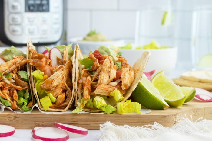 Shredded Chicken Tacos on a cutting board