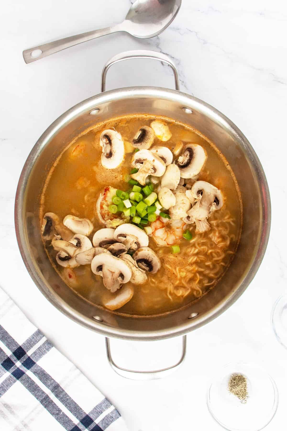 Shrimp soup with mushrooms in pot