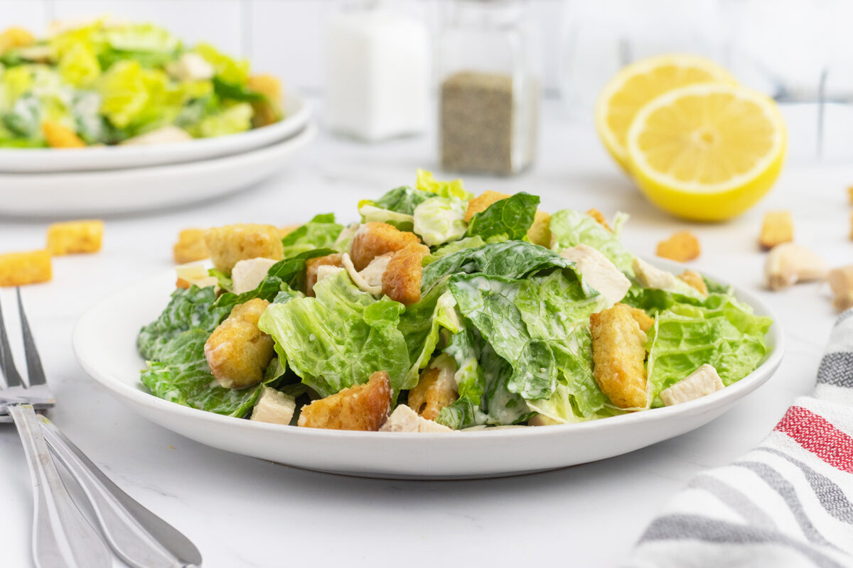 Chicken Caesar Salad with croutons on a white plate