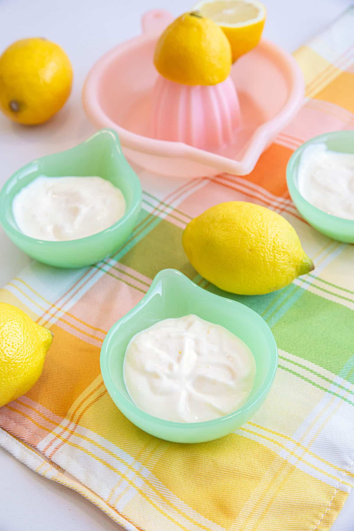 Lemon Aioli in small bowls with a whole lemon beside it