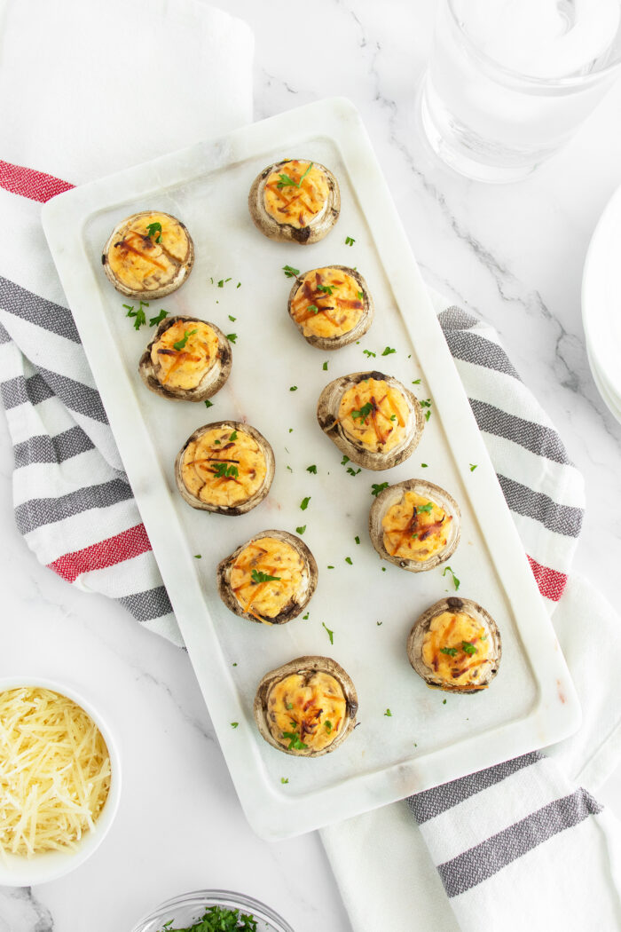 Stuffed Mushrooms lined up on a cutting board